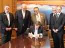 Gov John Hickenlooper (seated) signs the PRB-1 bill. Looking on were (L-R) Sen Chris Holbert, Colorado State Government Liaison Robert Wareham, N0ESQ, Colorado Section Manager Jack Ciaccia, WM0G, Colorado ARES member Richard Anderson, W9BNO, Rep Kevin Van Winkle. [John Maxwell, W0VG, photo]

 